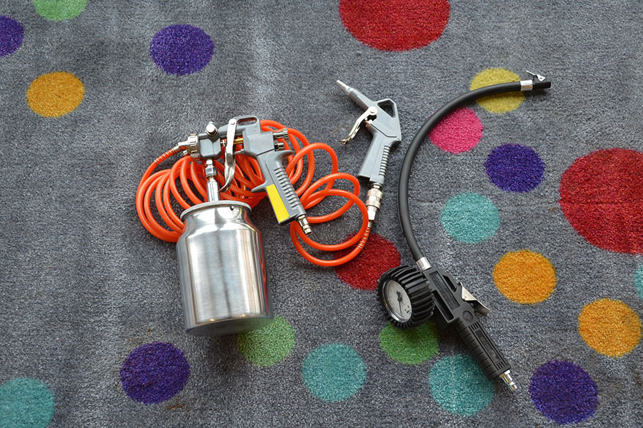 Image of a compressor gun tool denoting the tools of a metal painter that you need to know about