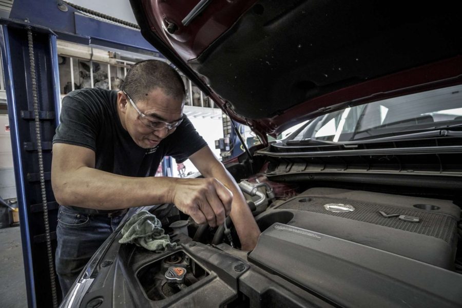 Man fixing an issue in motor mechanics of a vehicle