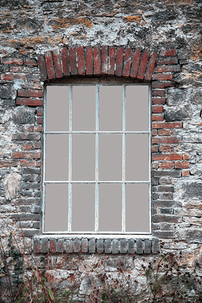 A window in a brick wall depicting weatherization installation