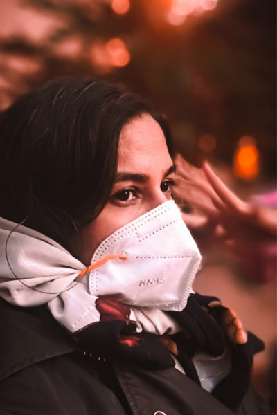 A woman wearing a mask denoting the impact of covid-19 on the generator industry