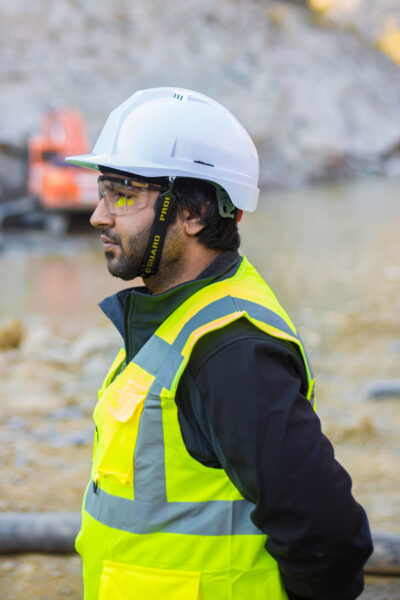 Image of a man wearing safety suit outdoors including safety glasses